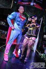 Superman and Batgirl working the stage at the Houston Halloween Erotica Ball. 